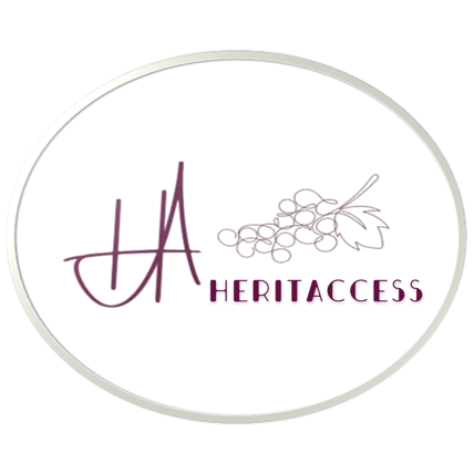 The heritaccess logo shows a circle in two lines with different dark shapes between like the top of a wine barrel. Inside the circle are a wine grape with leaves and grapes on the right side above a lettering heritaccess and calligraphy from H and A on the left side. The color is purple.